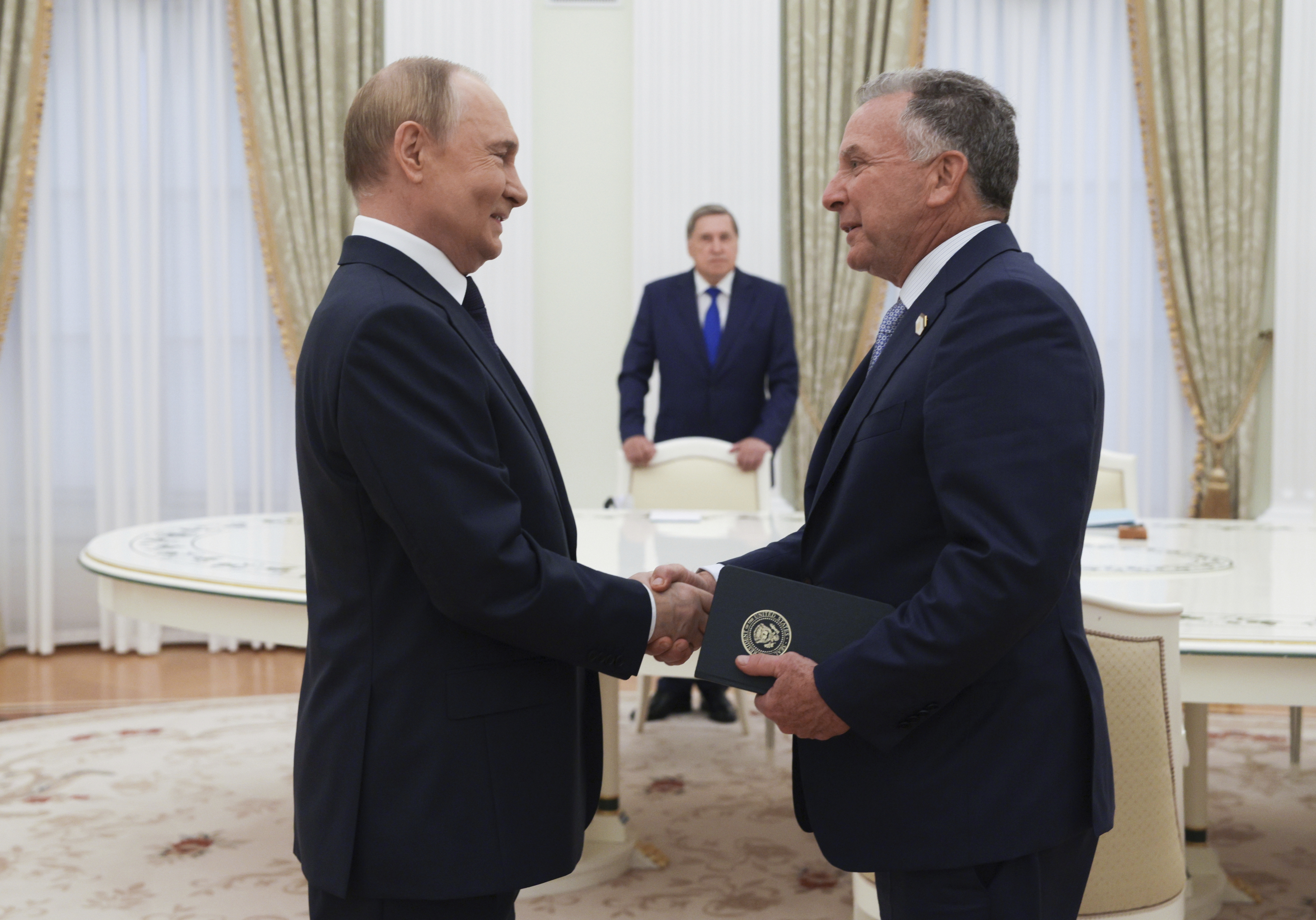 Russian President Vladimir Putin, left, and U.S. President Donald Trump's special envoy Steve Witkoff, right, shake hands during their meeting in Moscow, Russia, Wednesday, Aug. 6, 2025. (Gavriil Grigorov, Sputnik, Kremlin Pool Photo via AP)