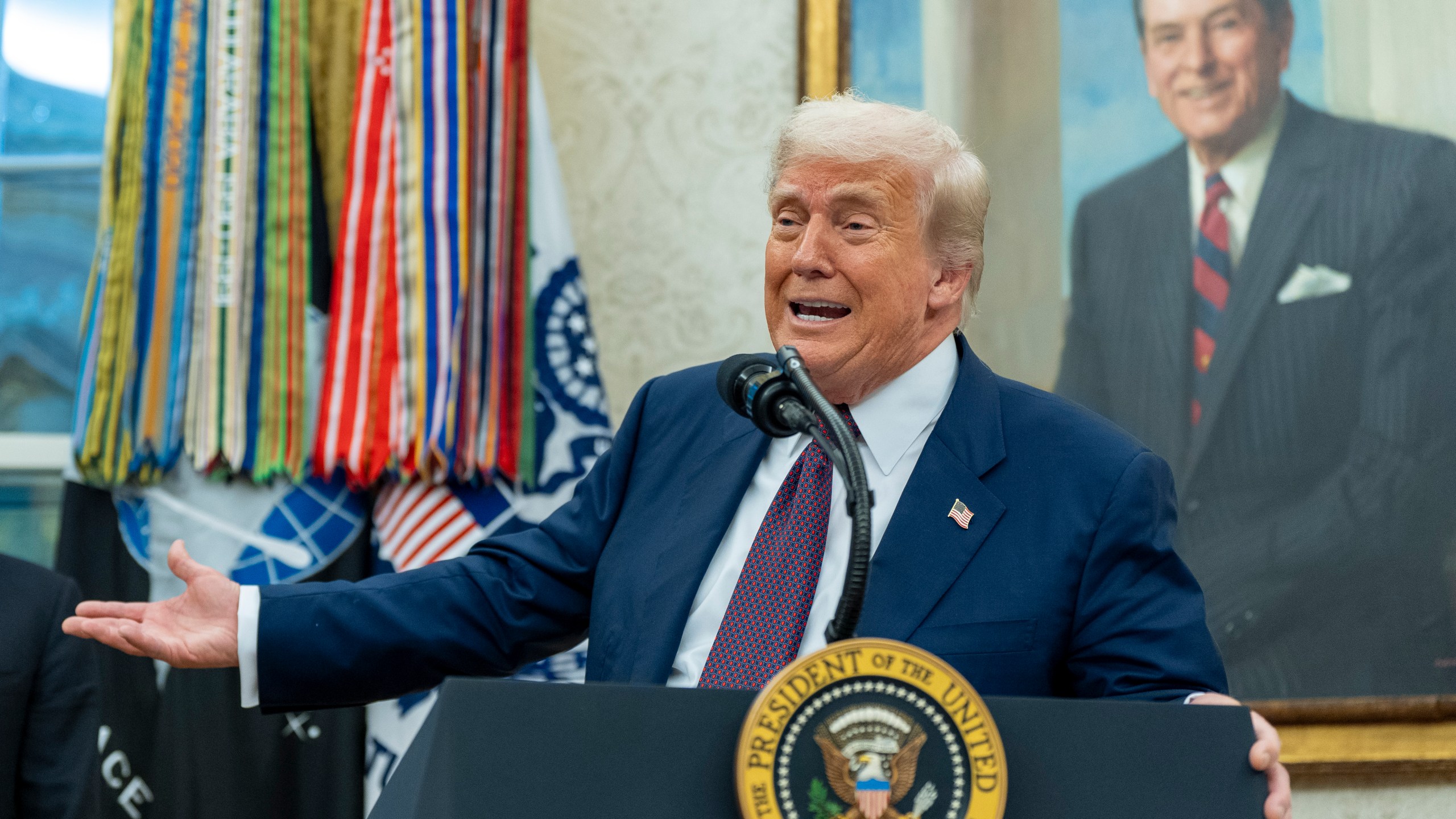President Donald Trump speaks while making an announcement about Apple with Apple CEO Tim Cook in the Oval Office, Wednesday, Aug. 6, 2025, in Washington. (AP Photo/Alex Brandon)