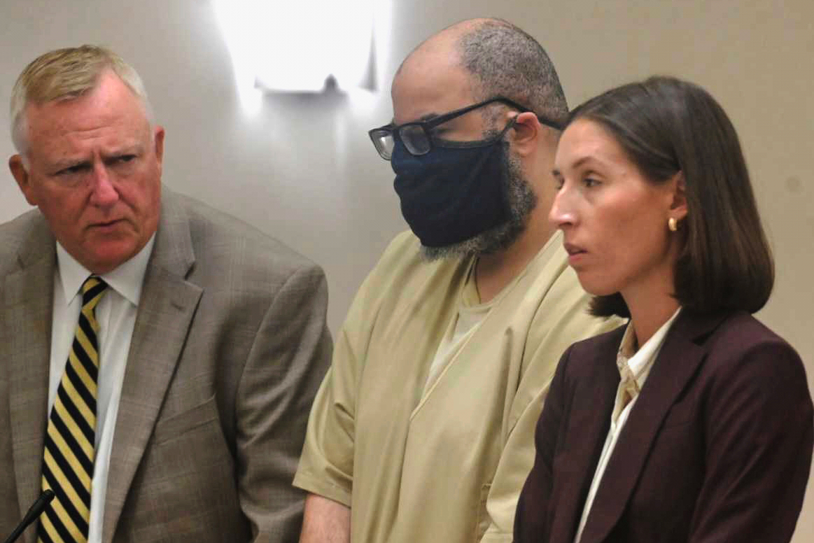 Michael Reese, center, stands with his attorneys Michael Miller and Shannon Lazier during his sentencing hearing in Connecticut Superior Court, in Danielson, Conn., on Friday, Aug. 8, 2025. (Jim Michaud/Hearst Connecticut Media via AP, Pool)