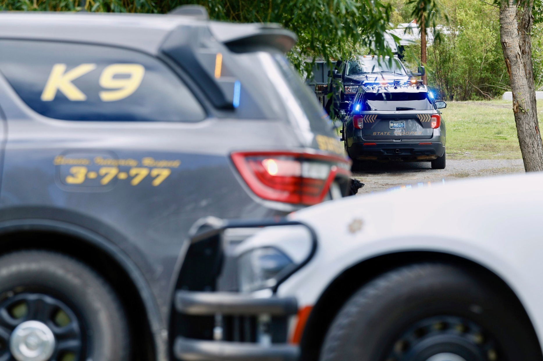 Law enforcement vehicles are parked at the scene where Michael Paul Brown, a suspect in a shooting at a Montana bar that left four people dead, was apprehended on Friday, Aug. 8, 2025, outside of Anaconda, Mont. (Joseph Scheller/The Montana Standard via AP)