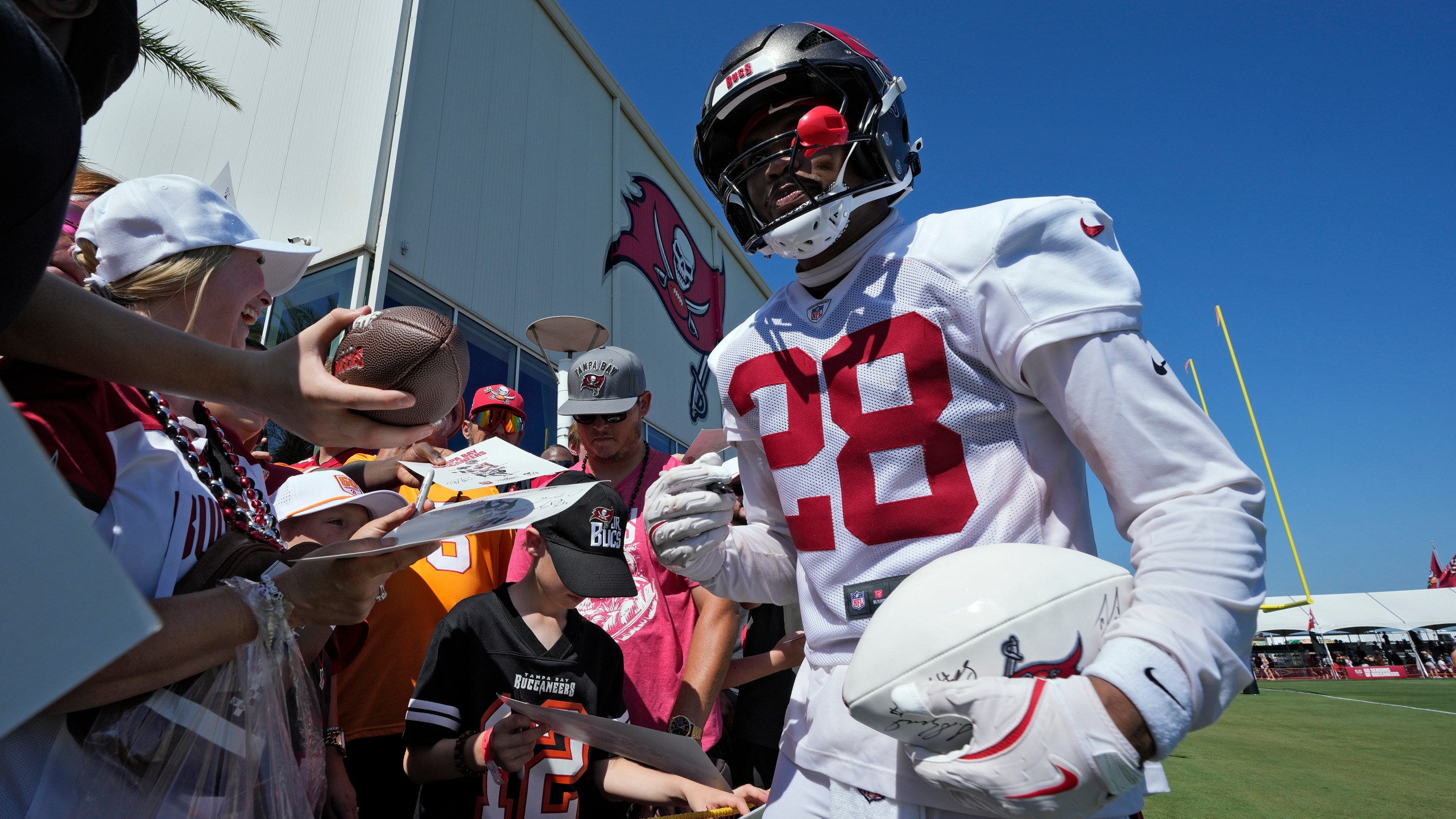 Tampa Bay Buccaneers safety Shilo Sanders signs autographs for fans during Back Together Weekend at an NFL football training camp practice Sunday, July 27, 2025, in Tampa, Fla. (AP Photo/Chris O'Meara)