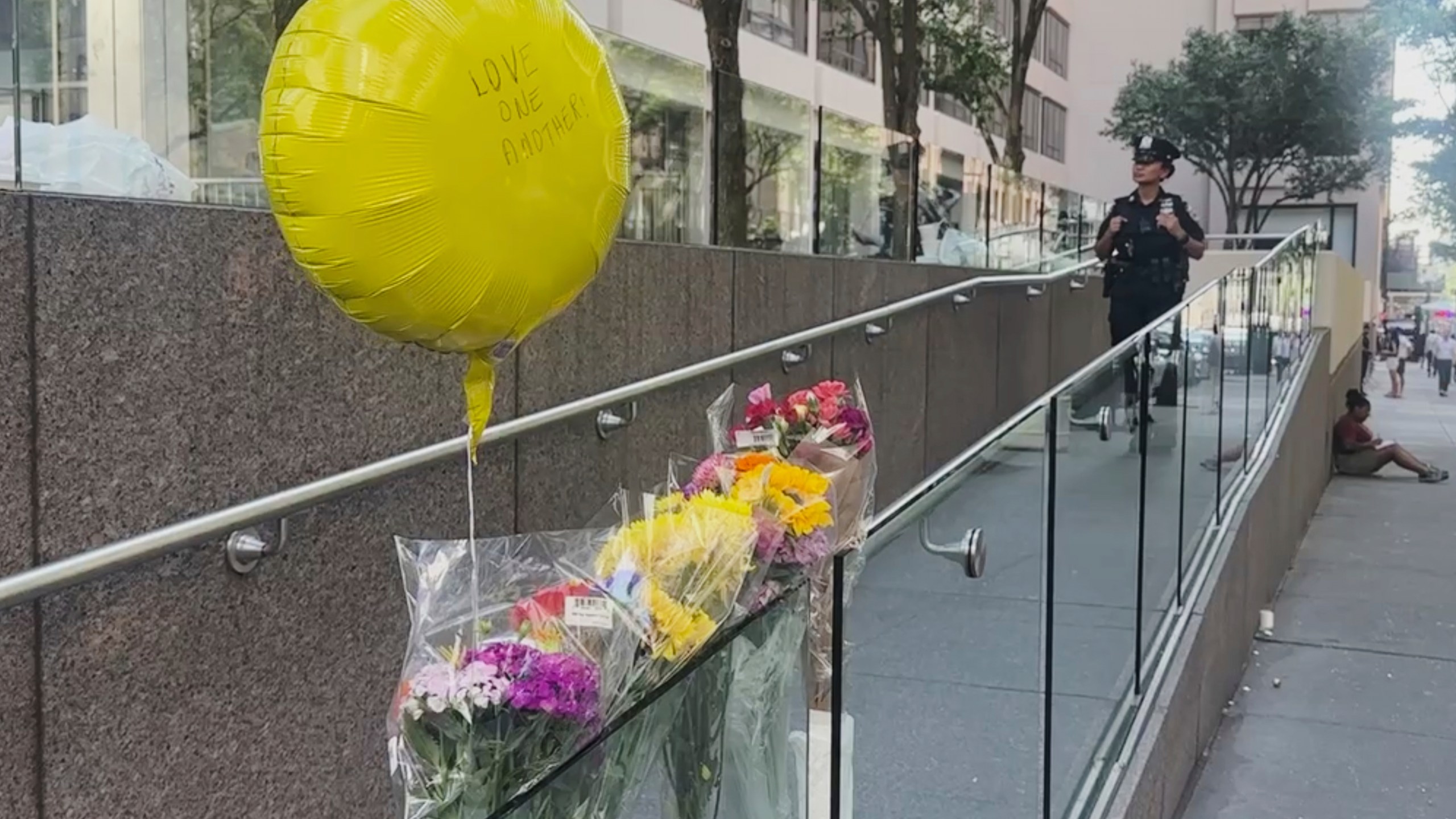 A police officer stands by a make shift memorial outside scene of Monday's deadly shooting on Tuesday, July 29, 2025 in New York. (AP Photo/Ted Shaffrey)