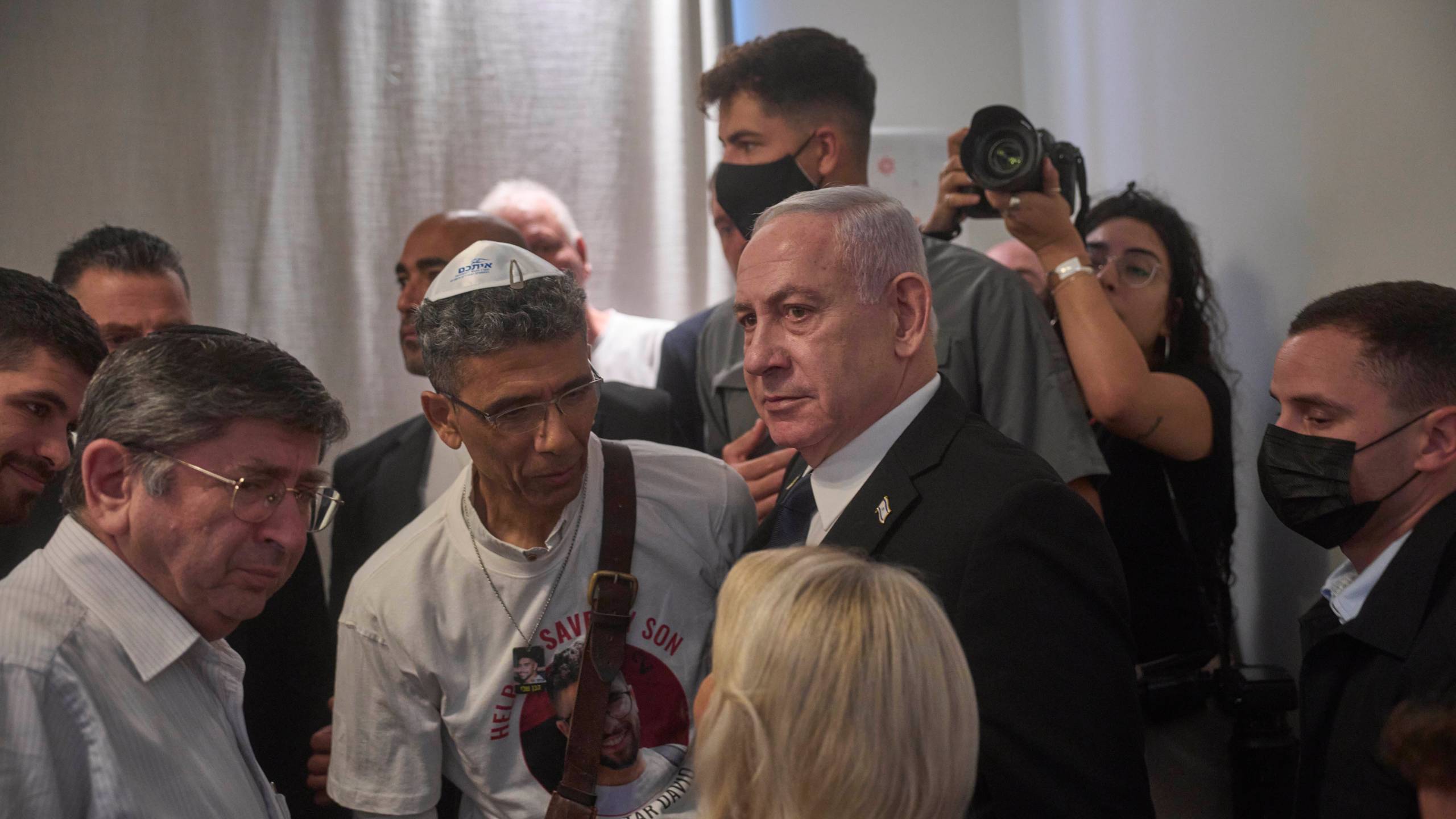 Israeli Prime Minister Benjamin Netanyahu speaks with family members of Israeli hostage Evyatar David at the opening ceremony of the Knesset Museum in the old building of the Israeli parliament, in Jerusalem, Monday, Aug.11, 2025. (AP Photo/Ohad Zwigenberg, Pool)
