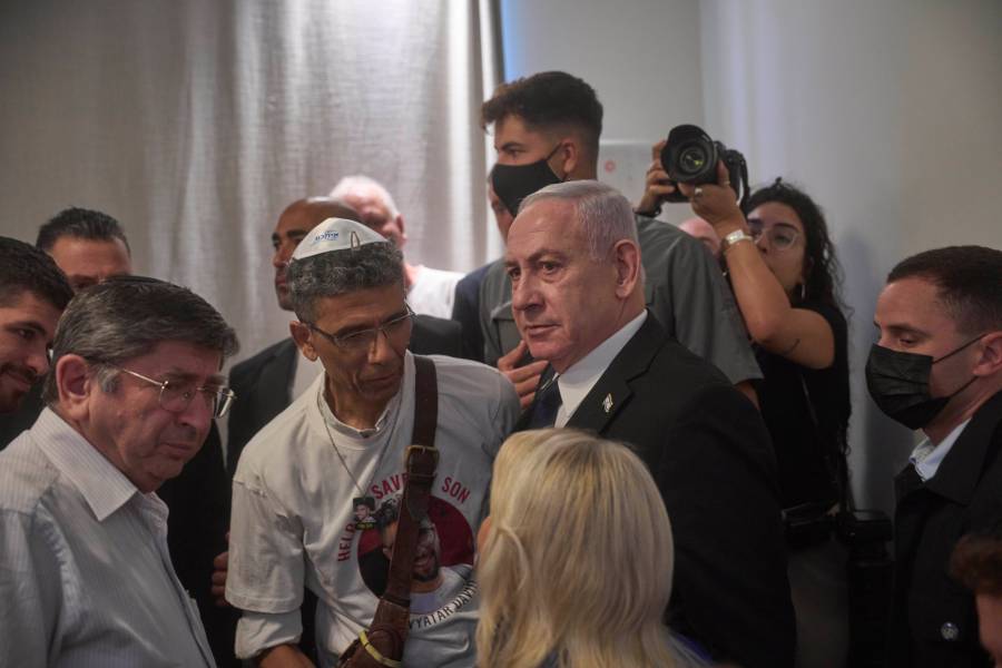 Israeli Prime Minister Benjamin Netanyahu speaks with family members of Israeli hostage Evyatar David at the opening ceremony of the Knesset Museum in the old building of the Israeli parliament, in Jerusalem, Monday, Aug.11, 2025. (AP Photo/Ohad Zwigenberg, Pool)