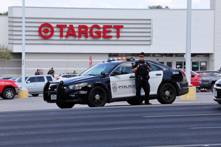 Police block the entrance to a Target after a shooting in Austin, Texas, Monday, Aug. 11, 2025. (AP Photo/Stephen Spillman)