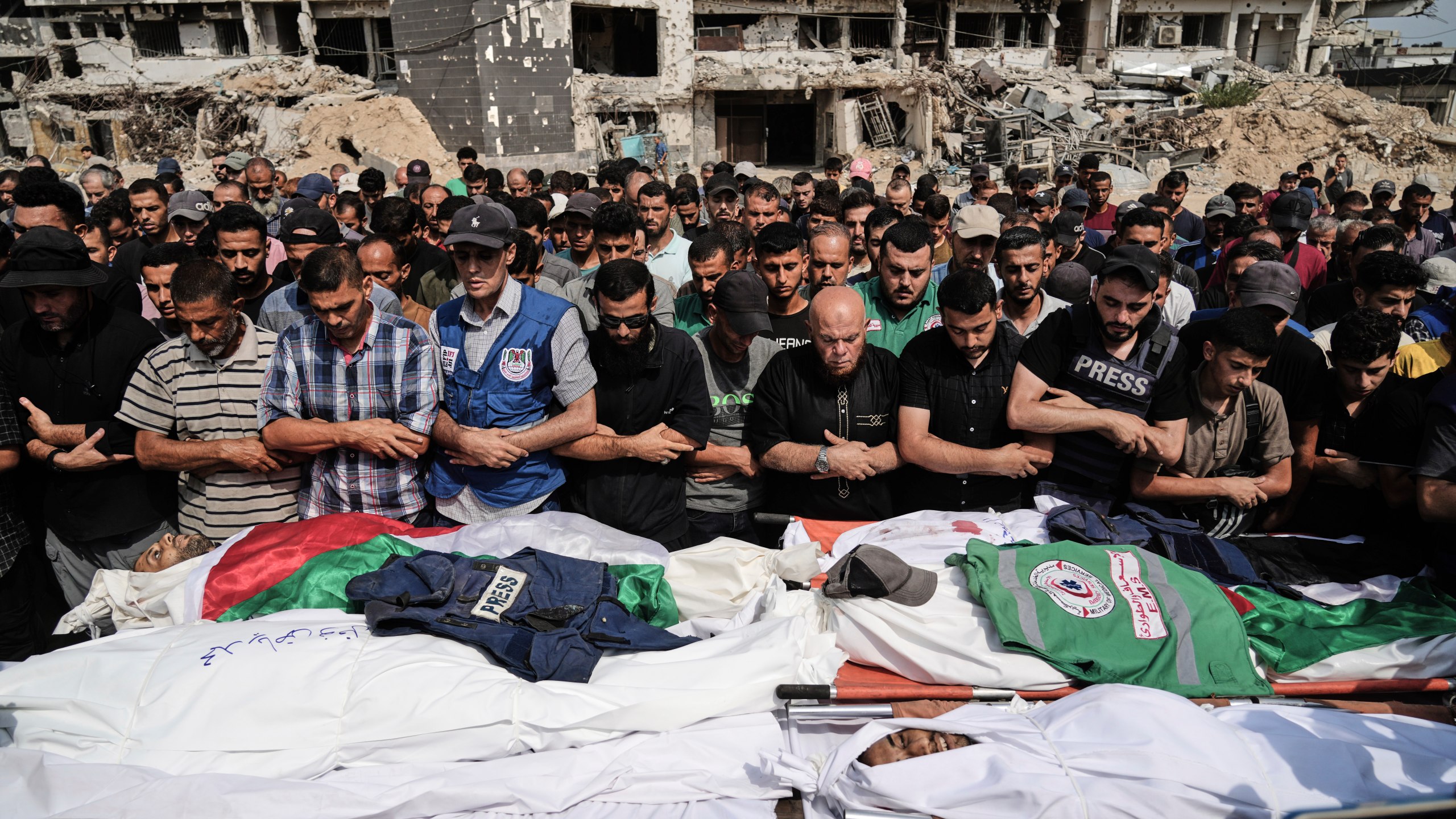 Palestinians pray over the bodies of journalists, including Al Jazeera correspondents Anas al-Sharif and Mohamed Qreiqeh, who were killed in an Israeli airstrike, during their funeral outside Gaza City's Shifa hospital complex, Monday, Aug. 11, 2025. (AP Photo/Jehad Alshrafi)