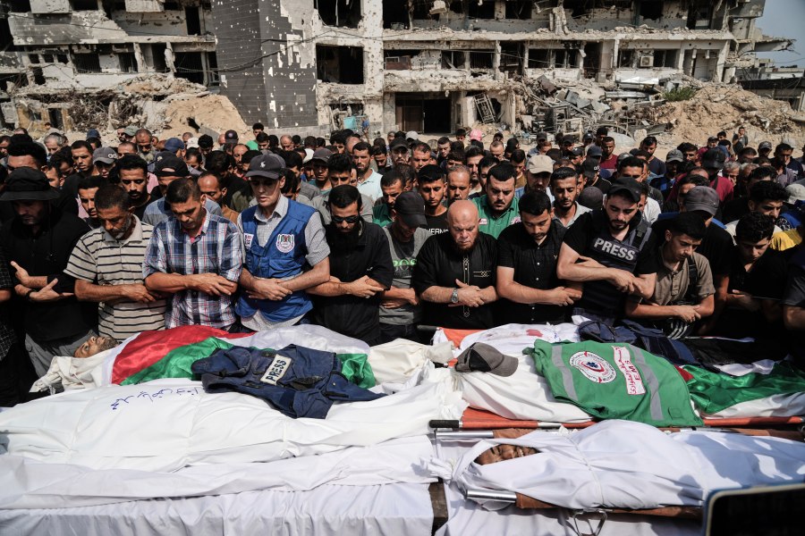 Palestinians pray over the bodies of journalists, including Al Jazeera correspondents Anas al-Sharif and Mohamed Qreiqeh, who were killed in an Israeli airstrike, during their funeral outside Gaza City's Shifa hospital complex, Monday, Aug. 11, 2025. (AP Photo/Jehad Alshrafi)