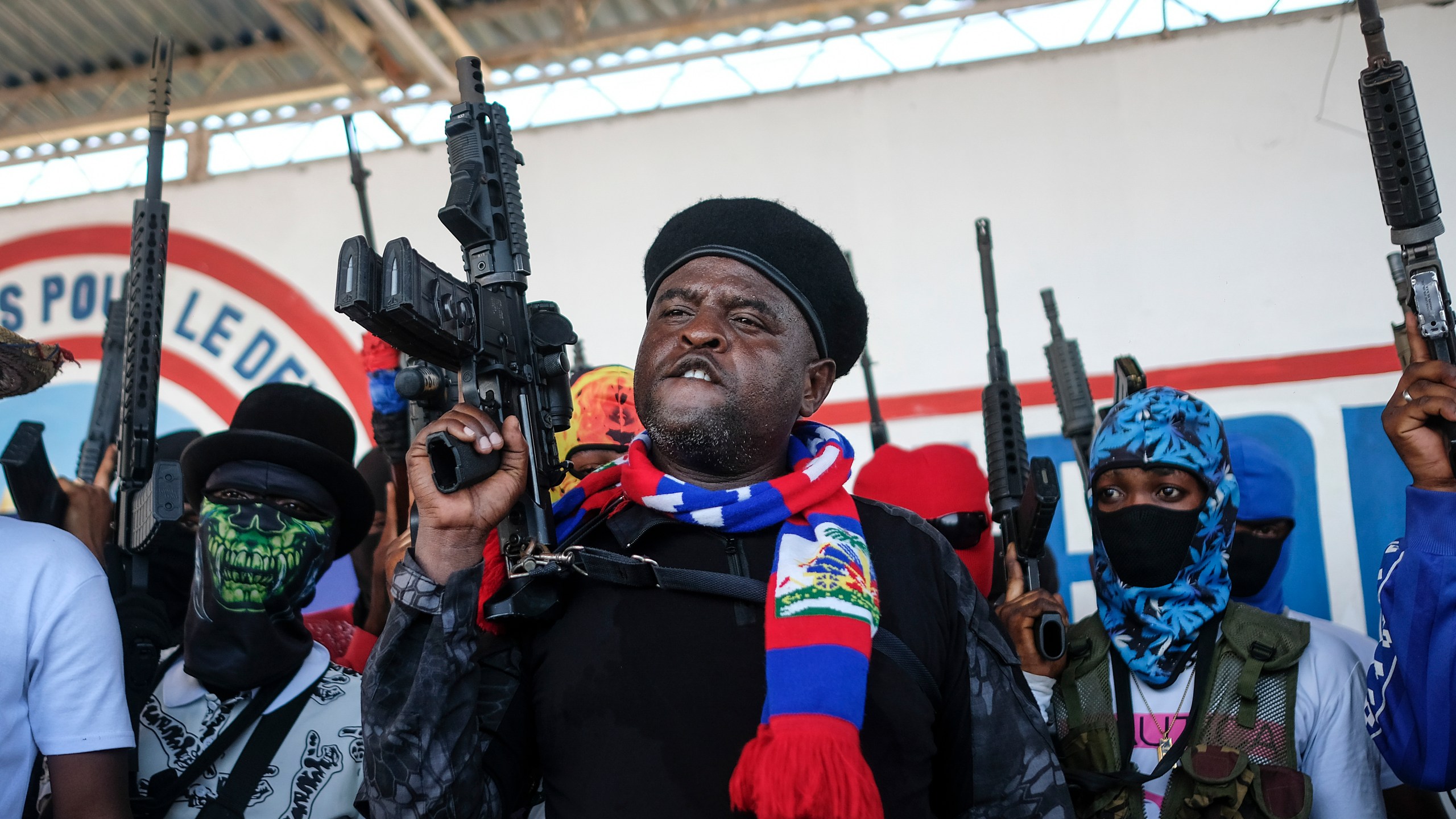 FILE - Leader of the "G9 and Family" gang, Jimmy Cherizier, better known as Barbecue, shouts slogans with his gang members after giving a speech, as he leads a march against kidnappings, through the La Saline neighborhood in Port-au-Prince, Haiti, Oct. 22, 2021. (AP Photo/Matias Delacroix, File)