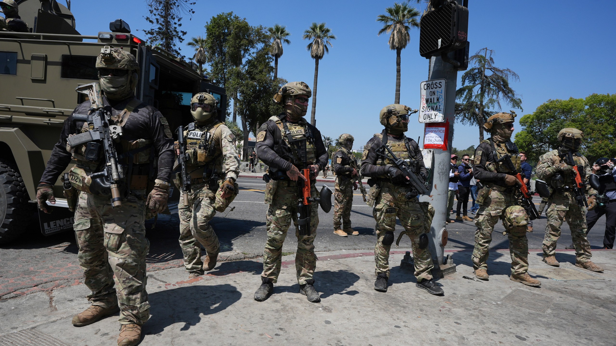 FILE - Federal agents stage at MacArthur Park, July 7, 2025, in Los Angeles. (AP Photo/Damian Dovarganes, File)