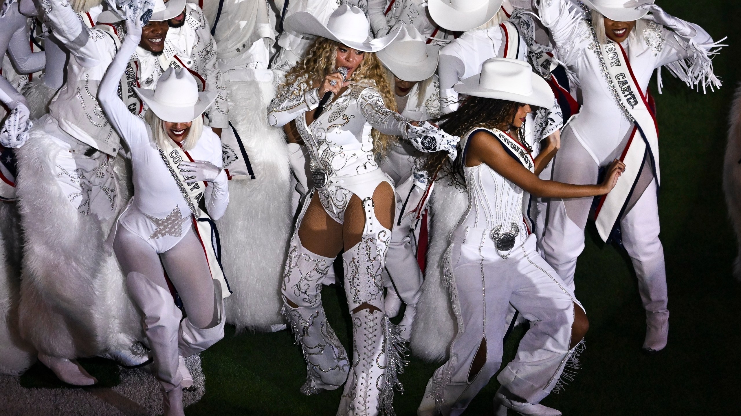 FILE - Beyoncé, center, is joined by her daughter Blue Ivy, right, during a halftime performance in an NFL football game between the Baltimore Ravens and the Houston Texans, Dec. 25, 2024, in Houston. (AP Photo/Maria Lysaker, File)