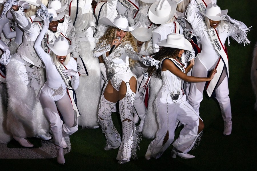FILE - Beyoncé, center, is joined by her daughter Blue Ivy, right, during a halftime performance in an NFL football game between the Baltimore Ravens and the Houston Texans, Dec. 25, 2024, in Houston. (AP Photo/Maria Lysaker, File)