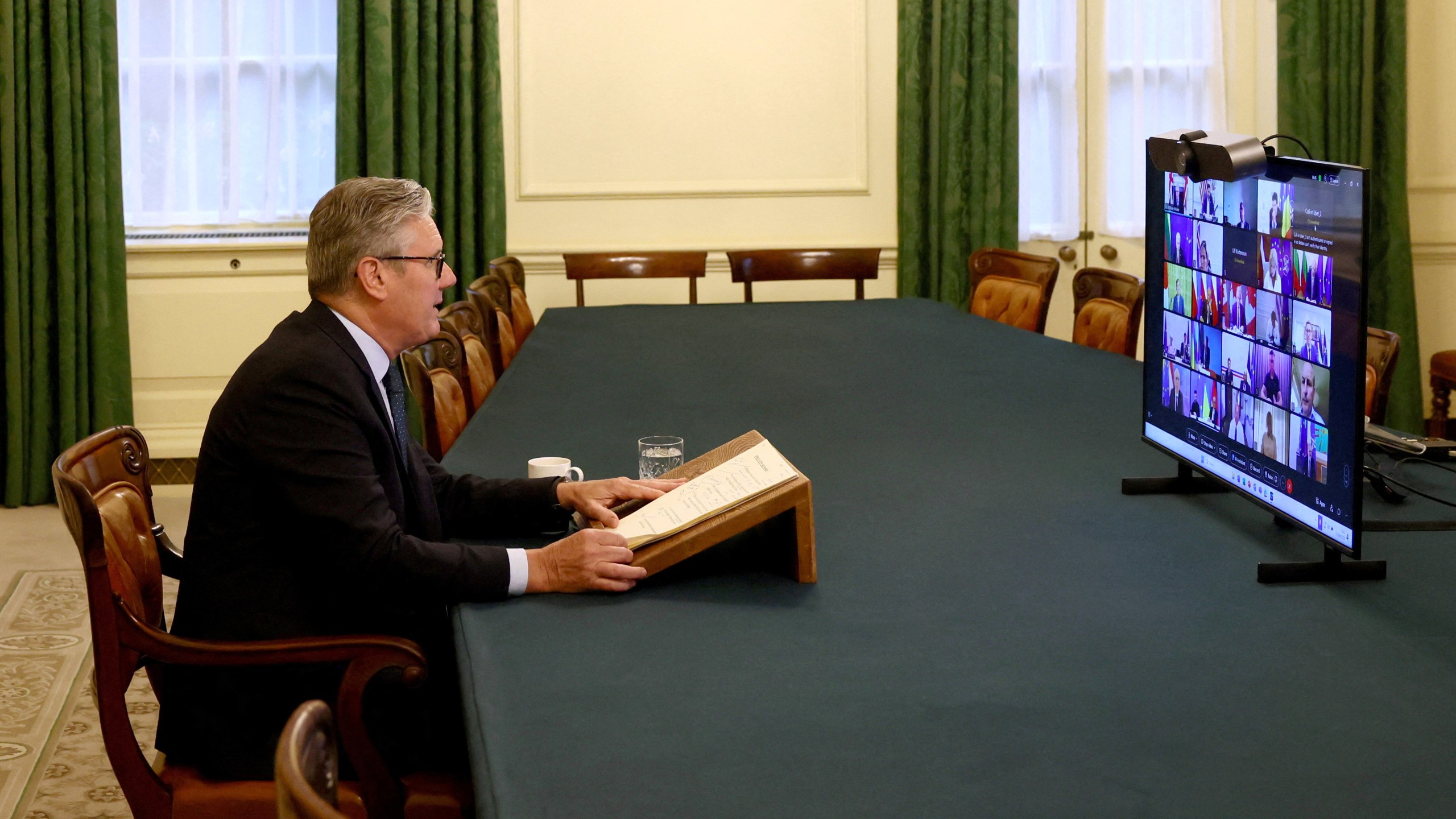 Britain's Prime Minister Keir Starmer co-chairs a videoconference call with European leaders on Ukraine, in London, Wednesday, Aug. 13, 2025. (Jack Taylor/Pool Photo via AP)