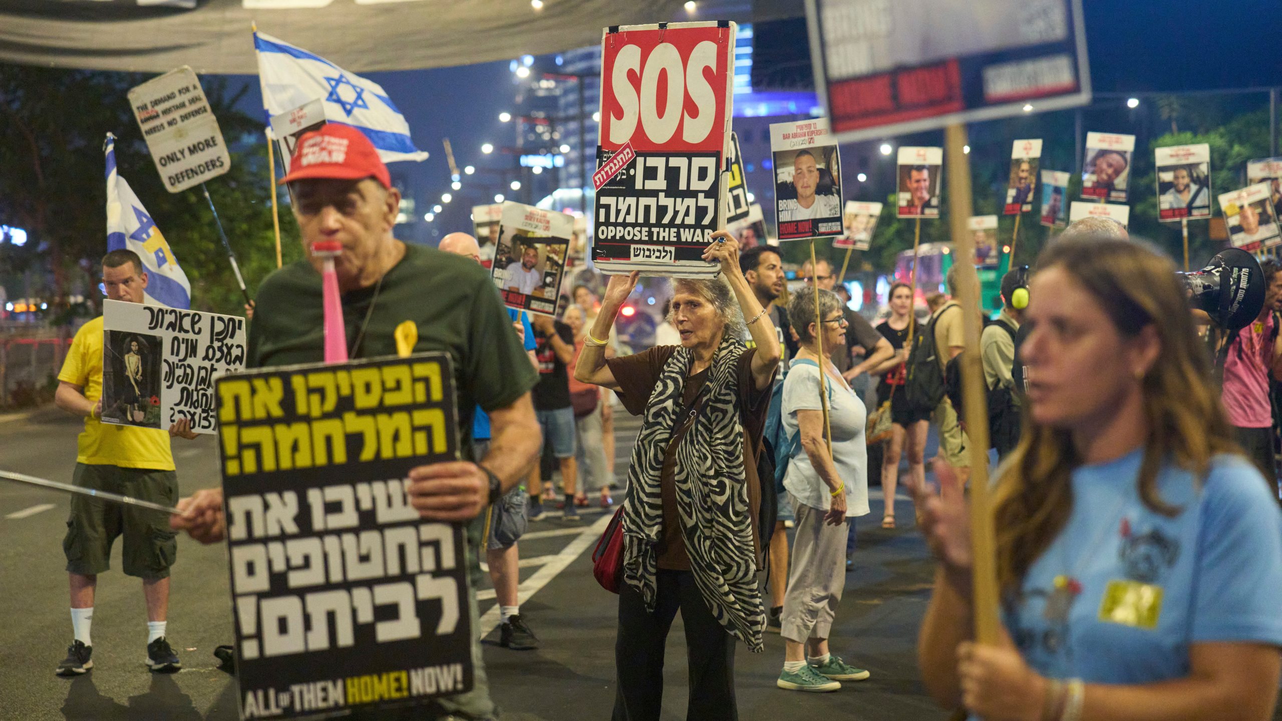 People take part in a protest demanding the end of the war and immediate release of hostages held by Hamas in the Gaza Strip, in Tel Aviv, Israel, Tuesday, Aug. 12, 2025. (AP Photo/Ariel Schalit)