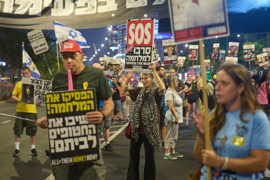 People take part in a protest demanding the end of the war and immediate release of hostages held by Hamas in the Gaza Strip, in Tel Aviv, Israel, Tuesday, Aug. 12, 2025. (AP Photo/Ariel Schalit)