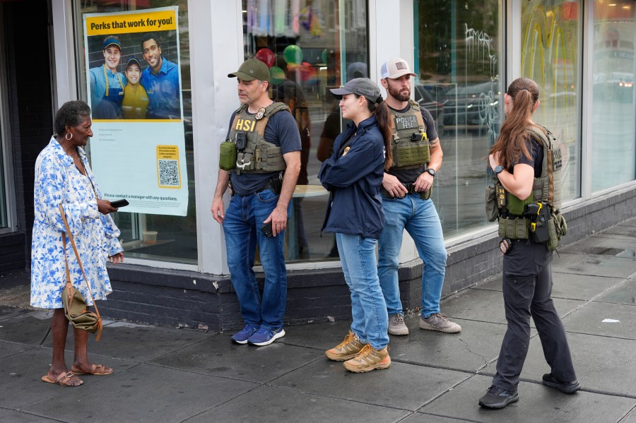 Department of Homeland Security Investigation officers stop to talk to a member of the community at the intersection of 14th and U Streets in northwest Washington, while on patrol Wednesday, Aug. 13, 2025. (AP Photo/Pablo Martinez Monsivais)