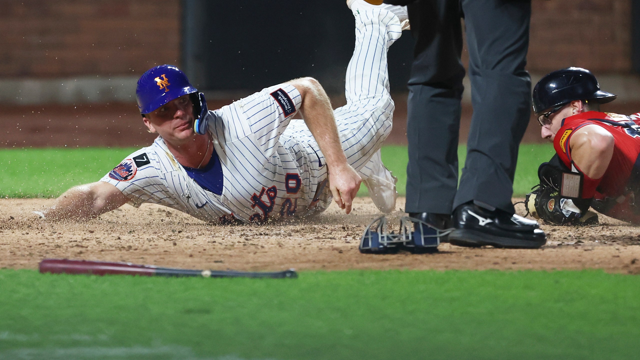 New York Mets first base Pete Alonso (20) is out at home plate as he slides past Atlanta Braves catcher Sean Murphy during the fourth inning of a baseball game, Wednesday, Aug. 13, 2025, in New York. (AP Photo/Heather Khalifa)