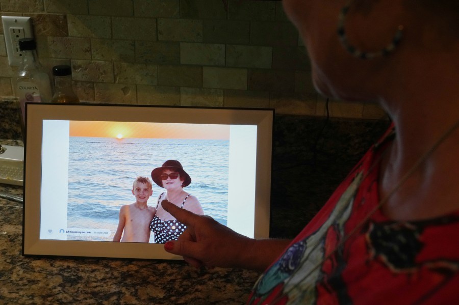 Julie Nicoll shows shows an undated photo with her grandson Xavier Thursday, April 24, 2025, in Naples, Fla. Julie and her husband have spent more than $20,000 in legal fees trying to get him released from a youth detention center. (AP Photo/Marta Lavandier)
