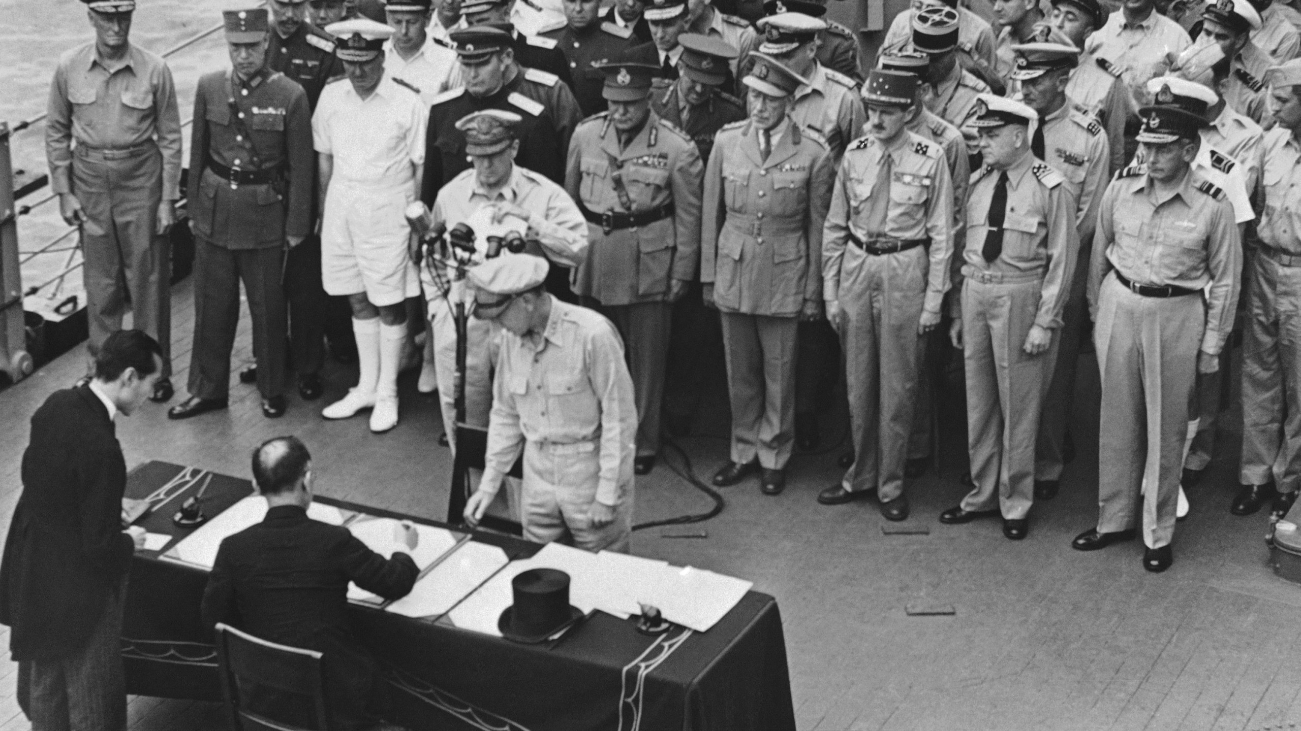FILE - Then Japanese Foreign Minister, Mamoru Shigemitsu signs the Japanese unconditional surrender papers for Emperor Hirohito aboard the U.S.S. Missouri in Tokyo harbor on Sept. 2, 1945. (AP Photo, File)