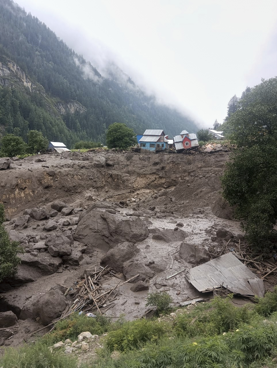 Buildings damaged in flash floods caused by torrential rains are seen in a remote, mountainous village, in Chositi area, Indian controlled Kashmir, Thursday, Aug. 14, 2025. (AP Photo)