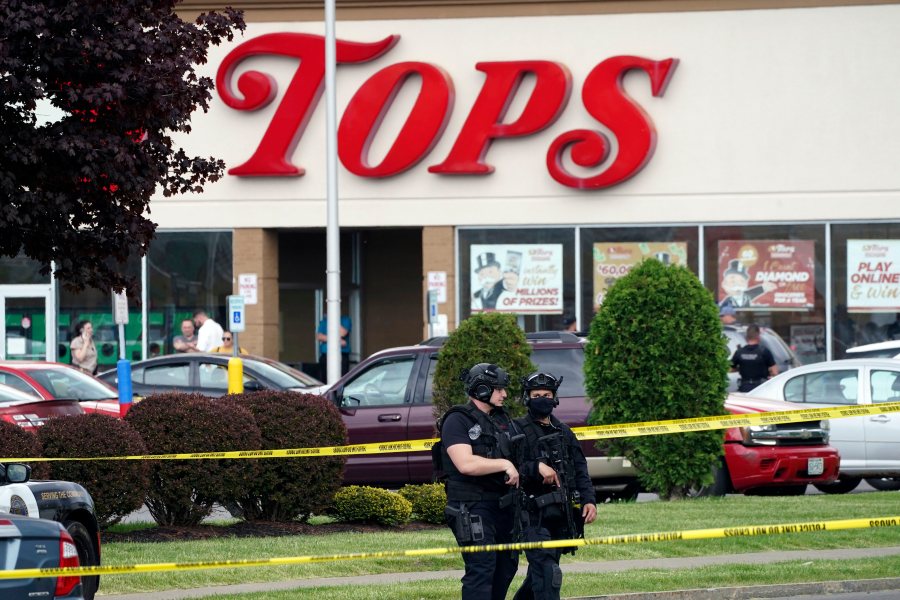 FILE - Police secure an area around a supermarket where several people were killed in a shooting, May 14, 2022 in Buffalo, N.Y. Relatives of victims of a racist mass shooting at a Buffalo supermarket have been called to federal court Friday, Jan. 12, 2024 for a "substantial update" in the legal case against Payton Gendron, their attorney said. (Derek Gee/The Buffalo News via AP, File)