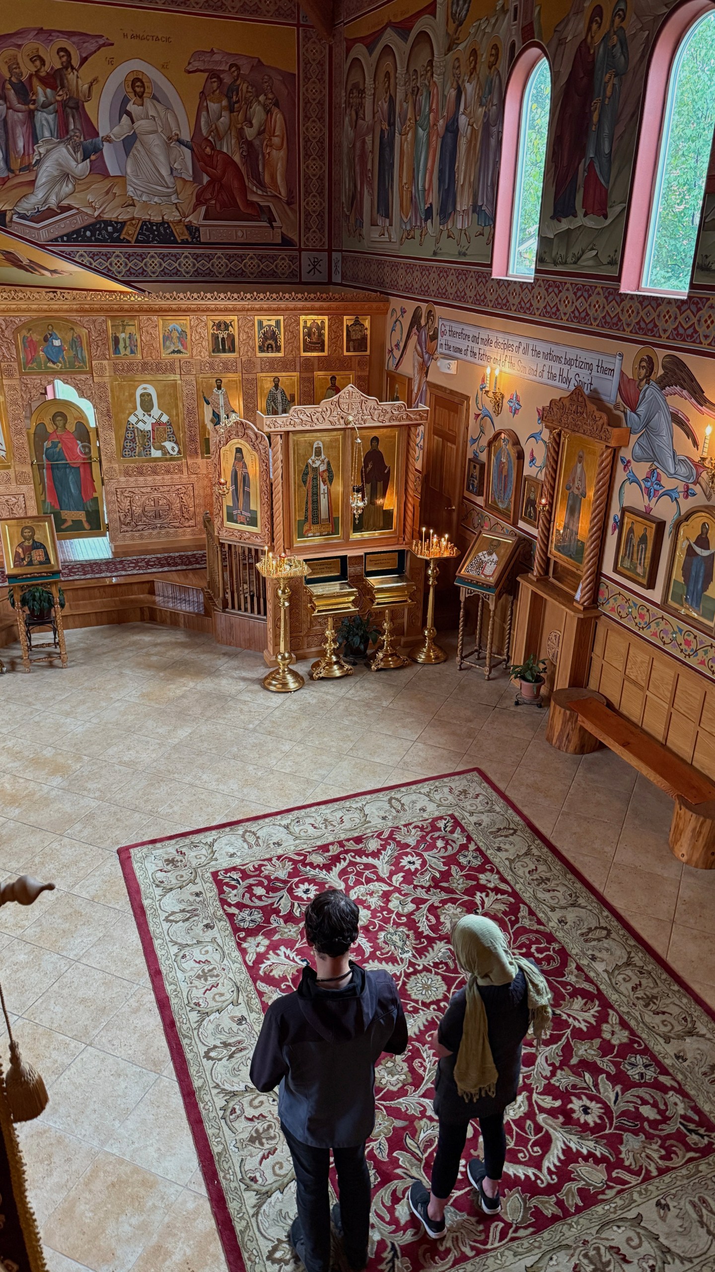 Two parishioners pray at St. Tikhon Orthodox Church in Anchorage during an Akathist service dedicated to peace in Ukraine on Wednesday, Aug. 13, 2025. (AP Photo/ Daniel Kozin)