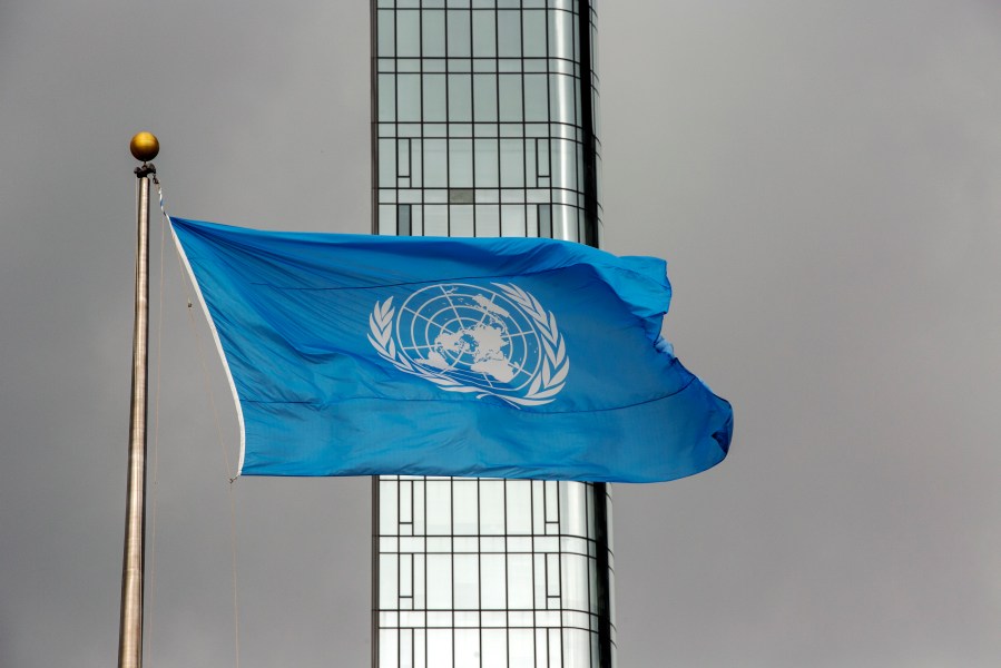 FILE - The UN flag flies on a stormy day at the United Nations during the United Nations General Assembly on Sept. 22, 2022. (AP Photo/Ted Shaffrey, File)