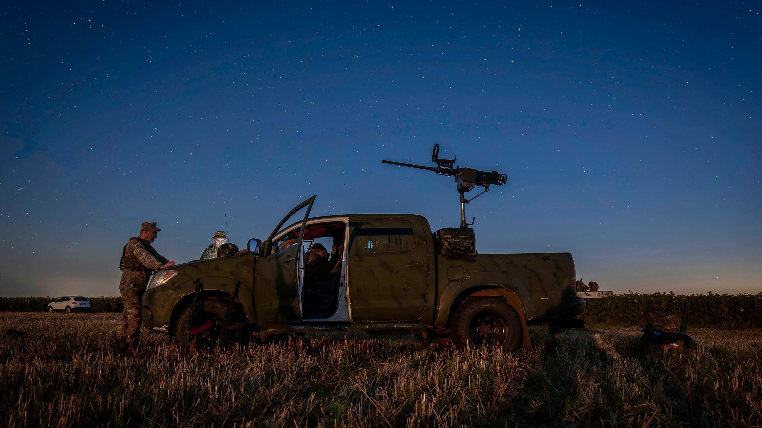 Ukrainian servicemen of the 15th Army Corps stand by an armed pickup truck during night duty in the Chernihiv region, Ukraine, late Tuesday, Aug. 12, 2025. (AP Photo/Dan Bashakov)