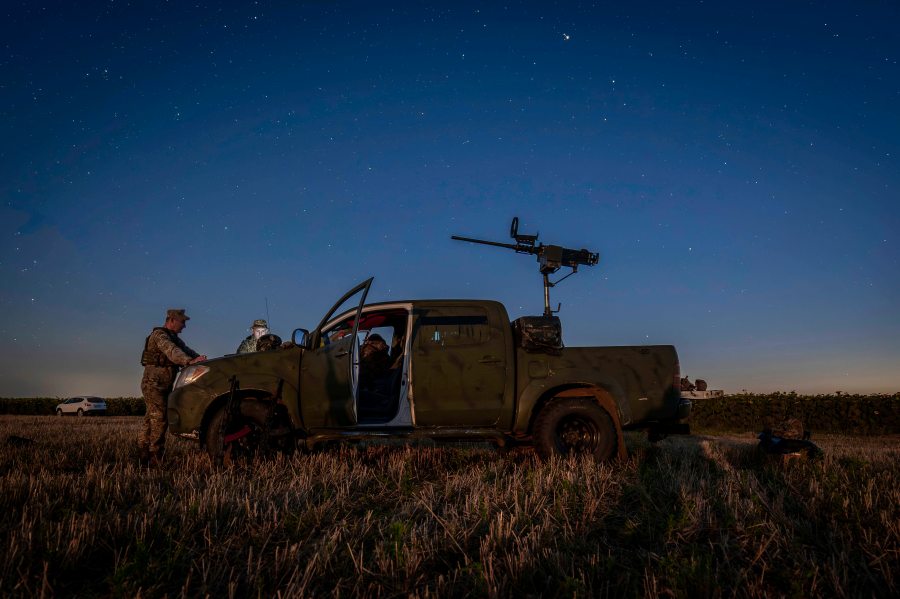 Ukrainian servicemen of the 15th Army Corps stand by an armed pickup truck during night duty in the Chernihiv region, Ukraine, late Tuesday, Aug. 12, 2025. (AP Photo/Dan Bashakov)