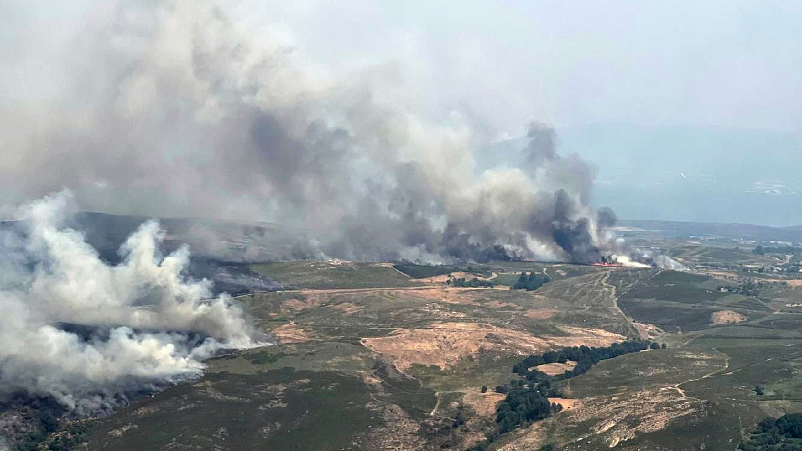 This recent photo taken from a French Canadair water bomber and provided Friday, Aug. 15, 2025 by the Securite Civile shows wildfire in Spain. (Securite Civile via AP)