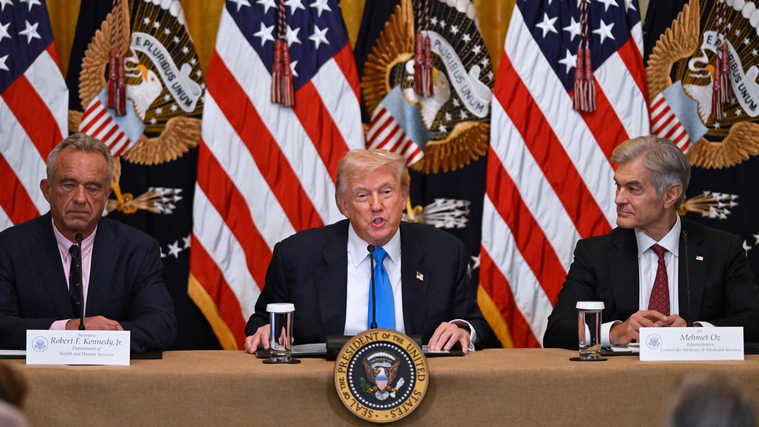 President Donald Trump speaks at an event to promote his proposal to improve Americans' access to their medical records, in the East Room of the White House, Wednesday, July 30, 2025, in Washington, as Health and Human Service Secretary Robert F. Kennedy, Jr., left, and Administrator of the Centers for Medicare and Medicaid Services, Mehmet Oz, right, look on. (AP Photo/John McDonnell)