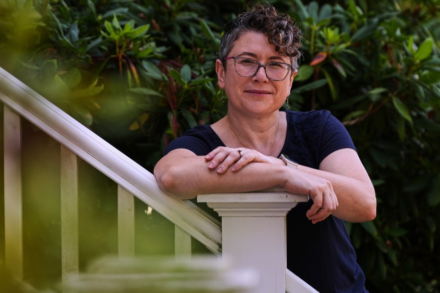 Ziva Mann, mother of a transgender child and member of a welcoming synagogue, poses outside her home, Wednesday, Aug. 13, 2025, in Newton, Mass. (AP Photo/Charles Krupa)