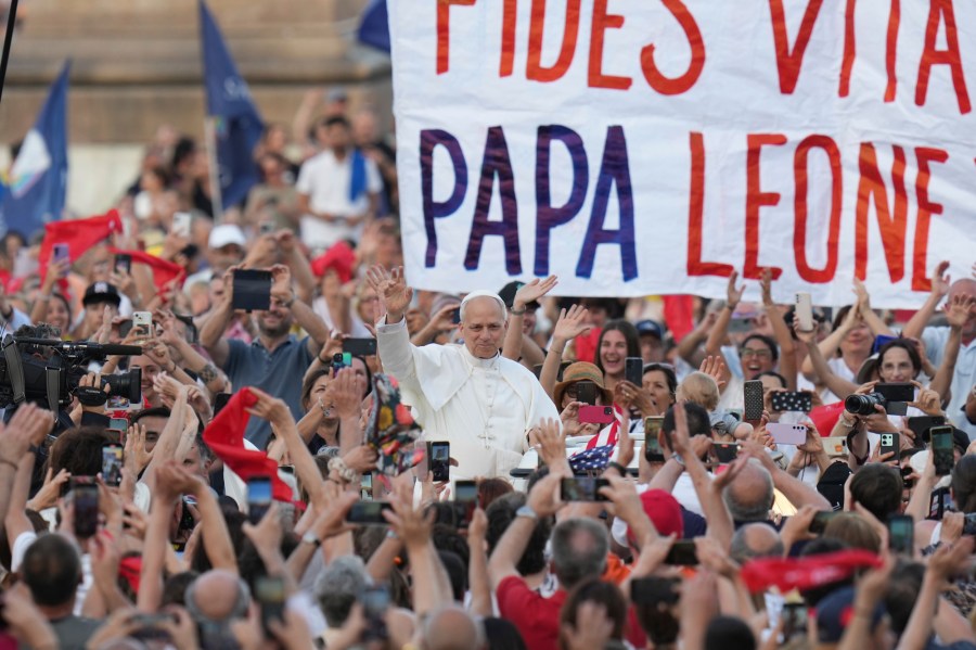 FILE - Pope Leo XIV waves as he arrives to hold a Pentecost vigil in St. Peter's Square at The Vatican, Saturday, June 8, 2025. (AP Photo/Alessandra Tarantino, File)