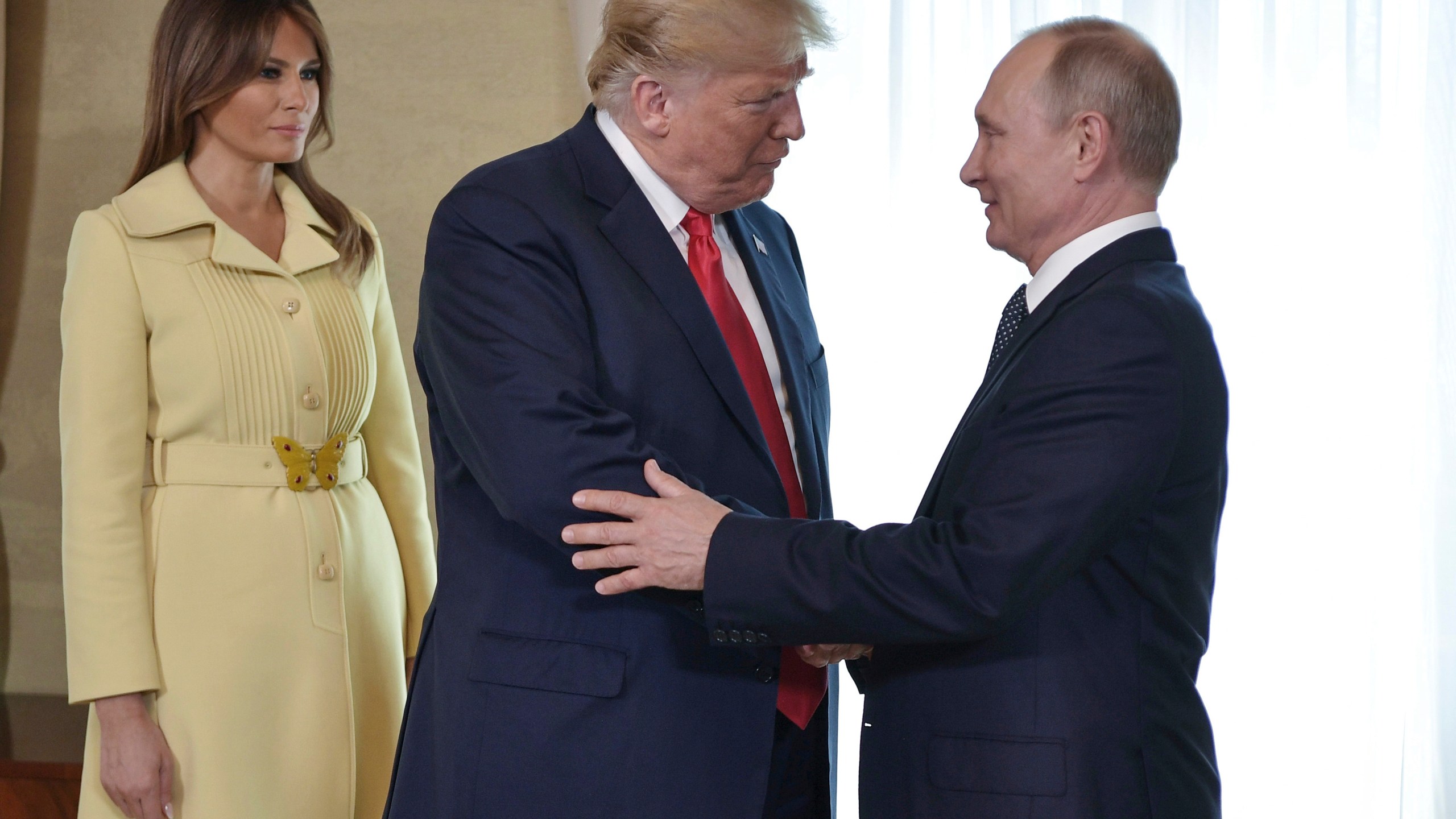 FILE - First lady Melania Trump, left, watches as President Donald Trump and Russian President Vladimir Putin welcome each other at the Presidential Palace in Helsinki, Finland, July 16, 2018, prior to Trump's and Putin's one-on-one meeting. (Alexei Nikolsky, Sputnik, Kremlin Pool Photo via AP)