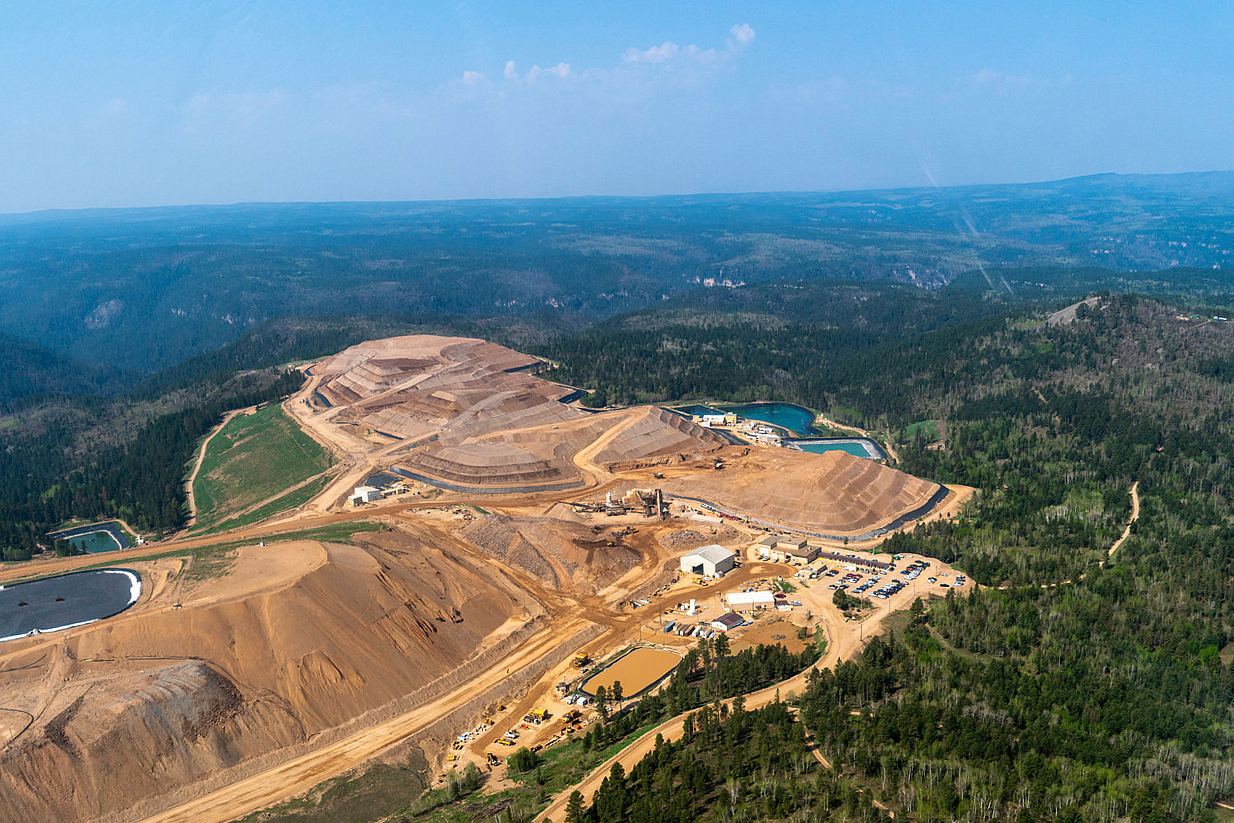 This image provided by EcoFlight shows an aerial view of Chicago-based Coeur Mining's Wharf gold mine nestled among the Black Hills on Tuesday, May 23, 2023. (EcoFlight via AP)