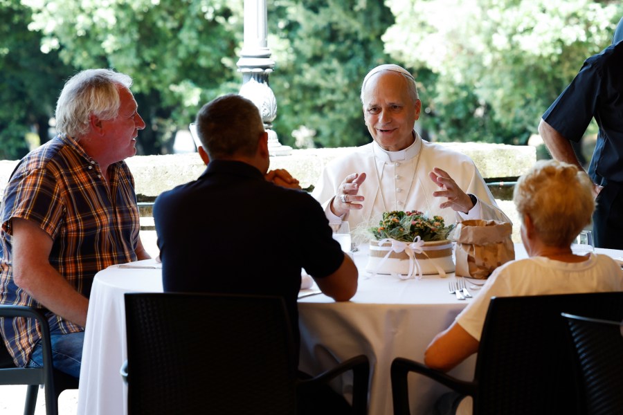 Pope Leo XIV attends a festive lunch with the poor of the Diocese of Albano Laziale at Borgo Laudato Si, in the garden of the Pontifical Villas in Castel Gandolfo, Italy, Sunday Aug. 17, 2025. (Remo Casilli/Pool via AP)