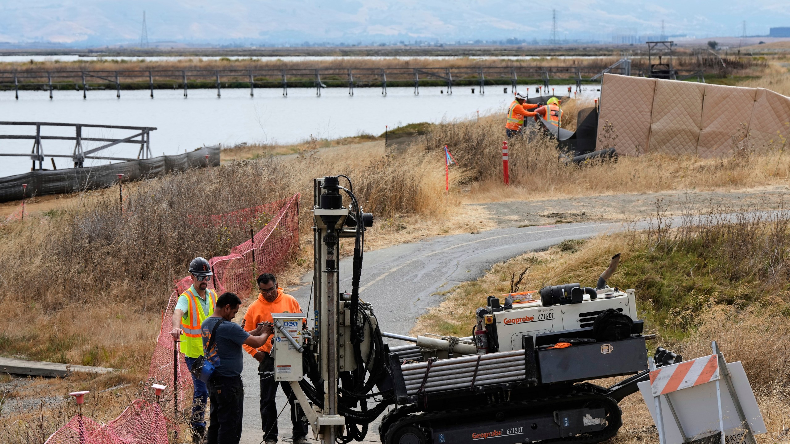 Crew members work on the Pond A2W site of the South Bay Salt Pond Restoration Project, Thursday, July 24, 2025, in Mountain View, Calif. (AP Photo/Godofredo A. Vásquez)