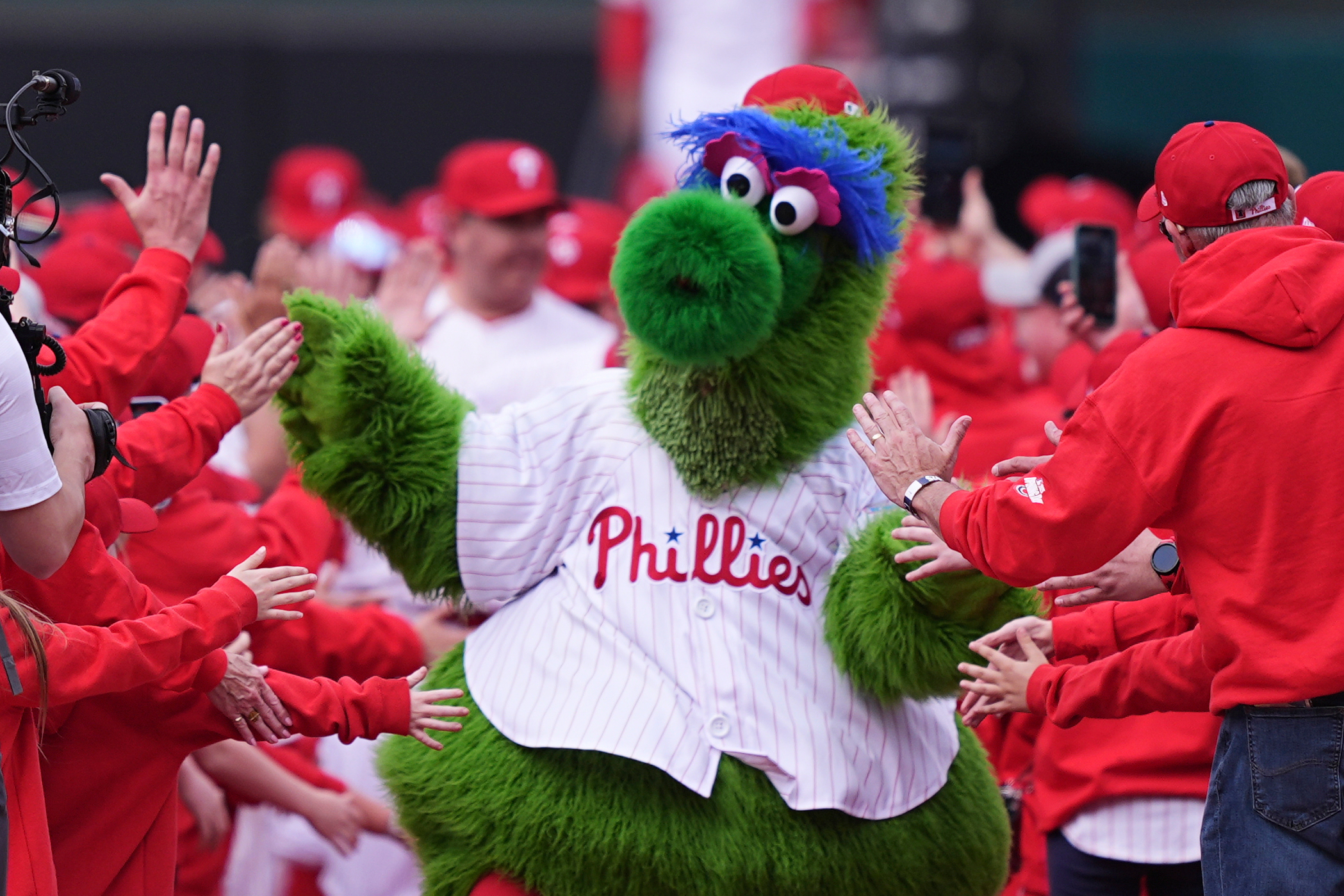 FILE - The Phillie Phanatic, the Philadelphia Phillies mascot, leads the team onto the field ahead for their home-opener baseball game against the Colorado Rockies, Monday, March 31, 2025, in Philadelphia. (AP Photo/Matt Rourke, File)