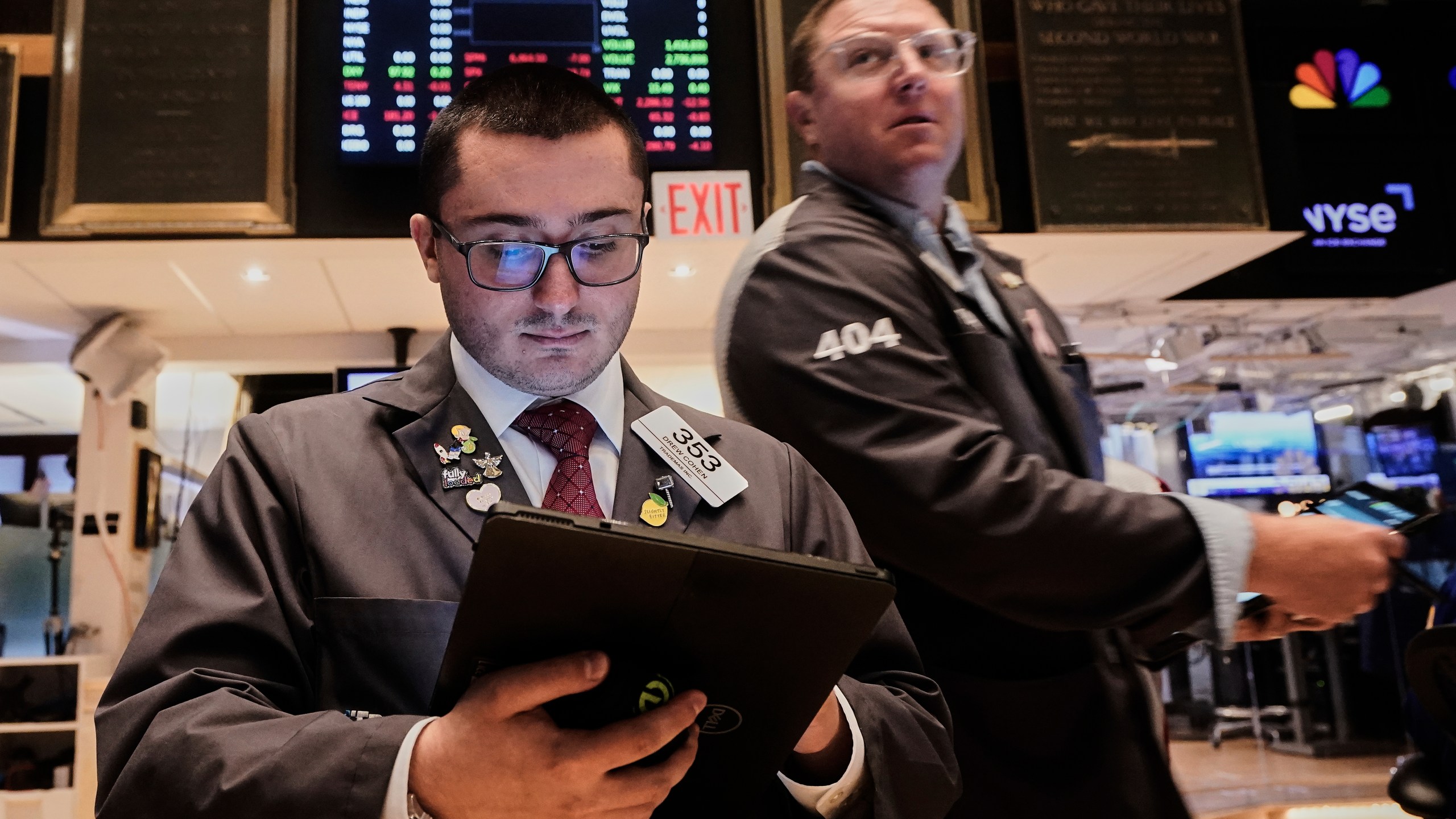 Traders Drew Cohen, left, and Ryan Falvey work on the floor of the New York Stock Exchange, Monday, Aug. 18, 2025. (AP Photo/Richard Drew)