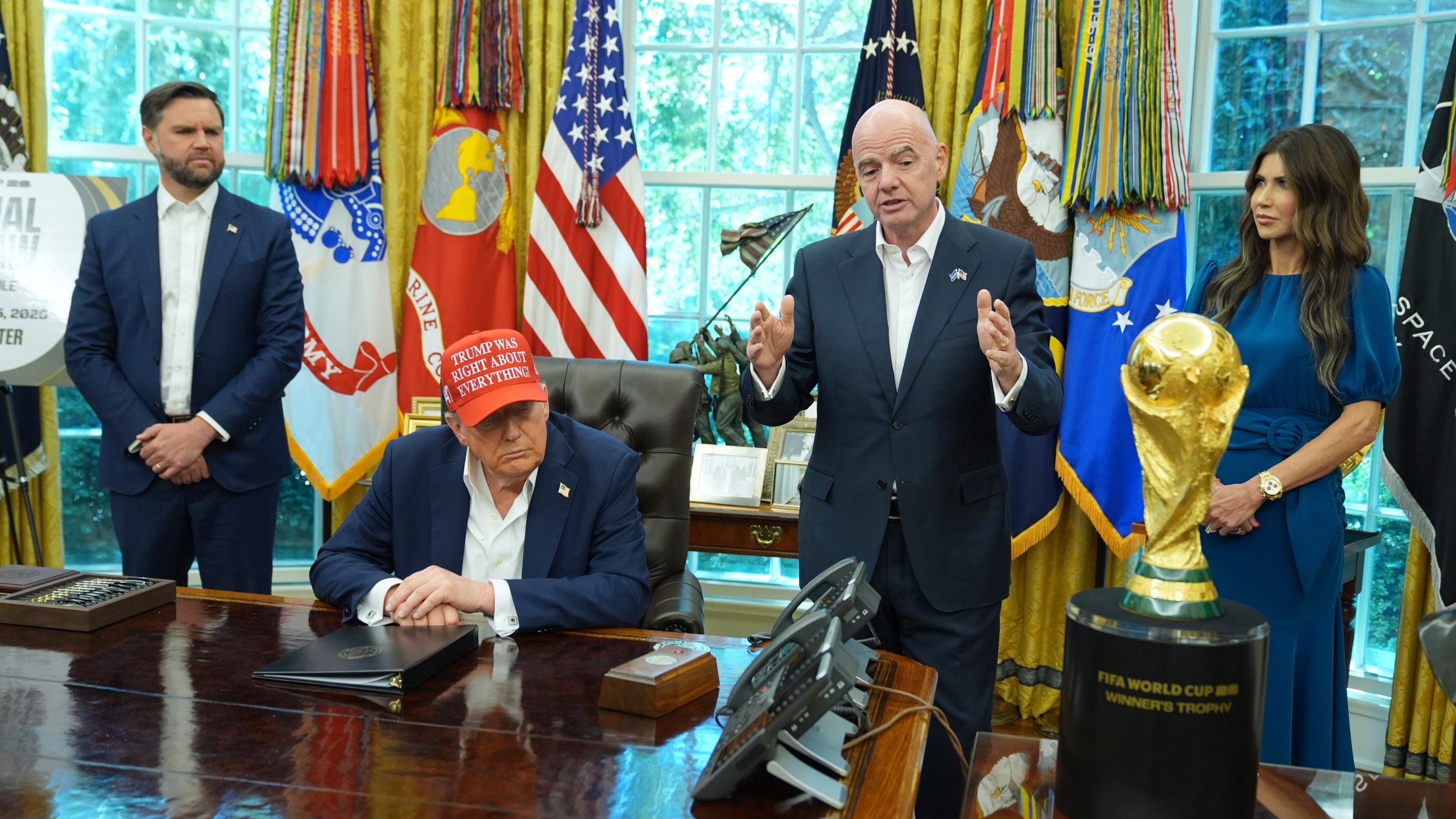 FIFA President Gianni Infantino speaks as Vice President JD Vance, from left, President Donald Trump and Homeland Security Secretary Kristi Noem listen in the Oval Office of the White House, Friday, Aug. 22, 2025, in Washington. (AP Photo/Jacquelyn Martin)