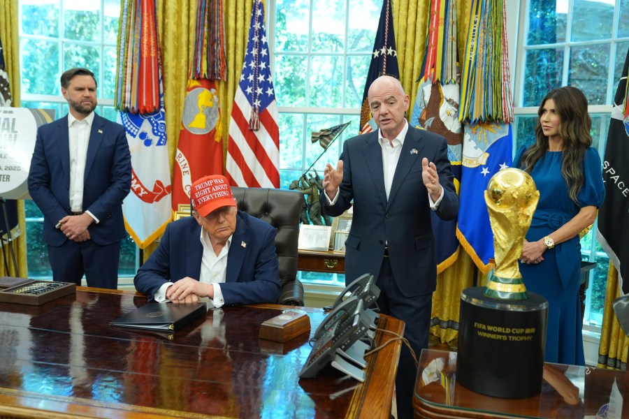 FIFA President Gianni Infantino speaks as Vice President JD Vance, from left, President Donald Trump and Homeland Security Secretary Kristi Noem listen in the Oval Office of the White House, Friday, Aug. 22, 2025, in Washington. (AP Photo/Jacquelyn Martin)