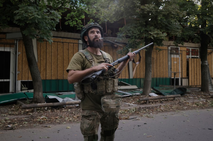 A Ukrainian soldier gets ready to fire at Russian FPV drones in the town of Kostiantynivka, the site of heavy battles with Russian troops in the Donetsk region, Ukraine, on Sunday, Aug. 24, 2025. (AP Photo/Yevhen Titov)