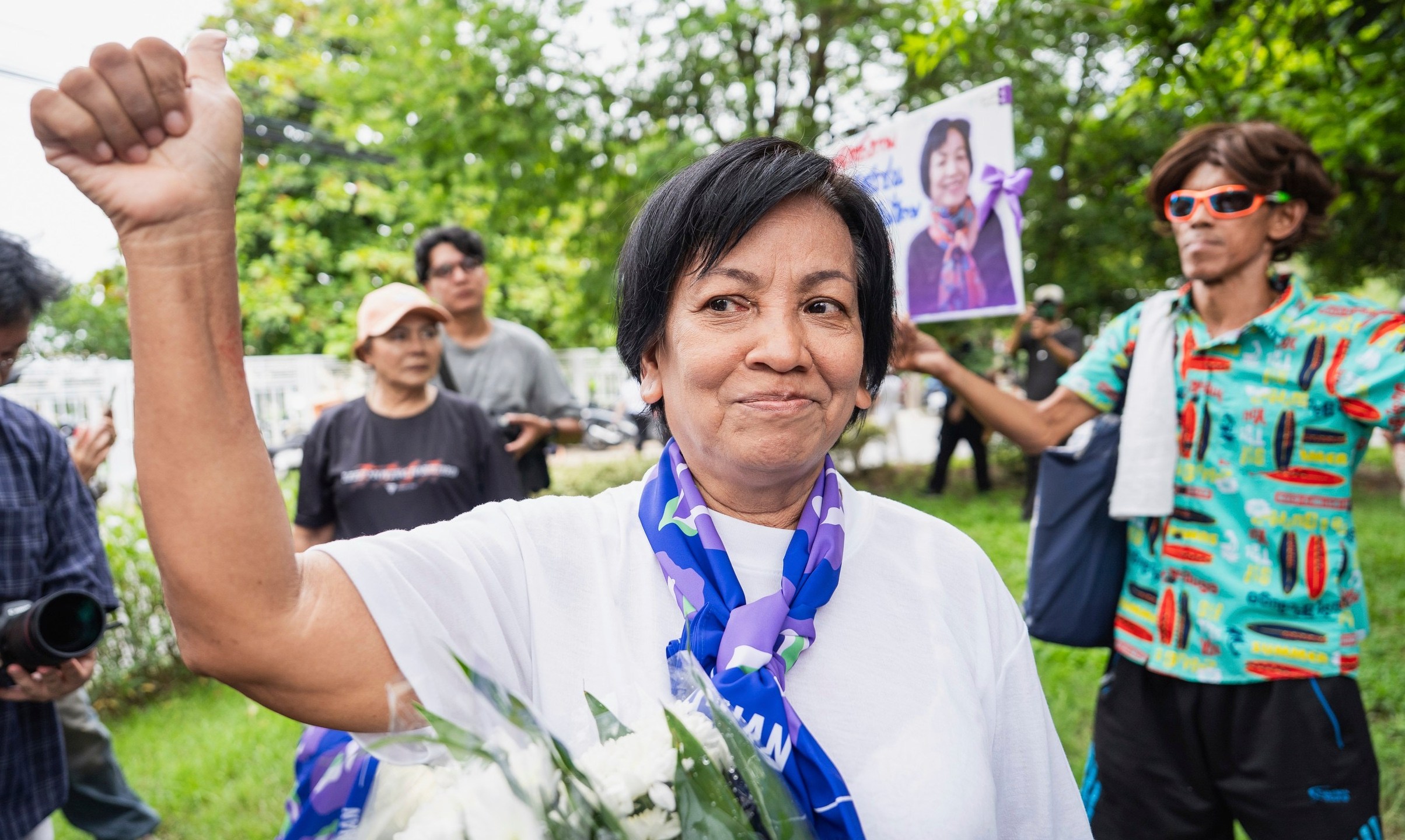 In this photo supplied by Amnesty International Thailand, Anchan Preelert greets well-wishers after her release by a royal pardon Wednesday, Aug. 27, 2025, from Central Women's Correctional Institution in Bangkok, Thailand, where she had spent years on a charge of royal defamation. (Amnesty International Thailand via AP)