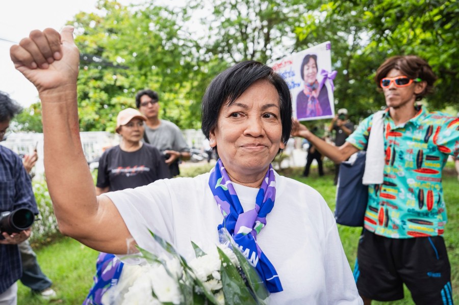 In this photo supplied by Amnesty International Thailand, Anchan Preelert greets well-wishers after her release by a royal pardon Wednesday, Aug. 27, 2025, from Central Women's Correctional Institution in Bangkok, Thailand, where she had spent years on a charge of royal defamation. (Amnesty International Thailand via AP)