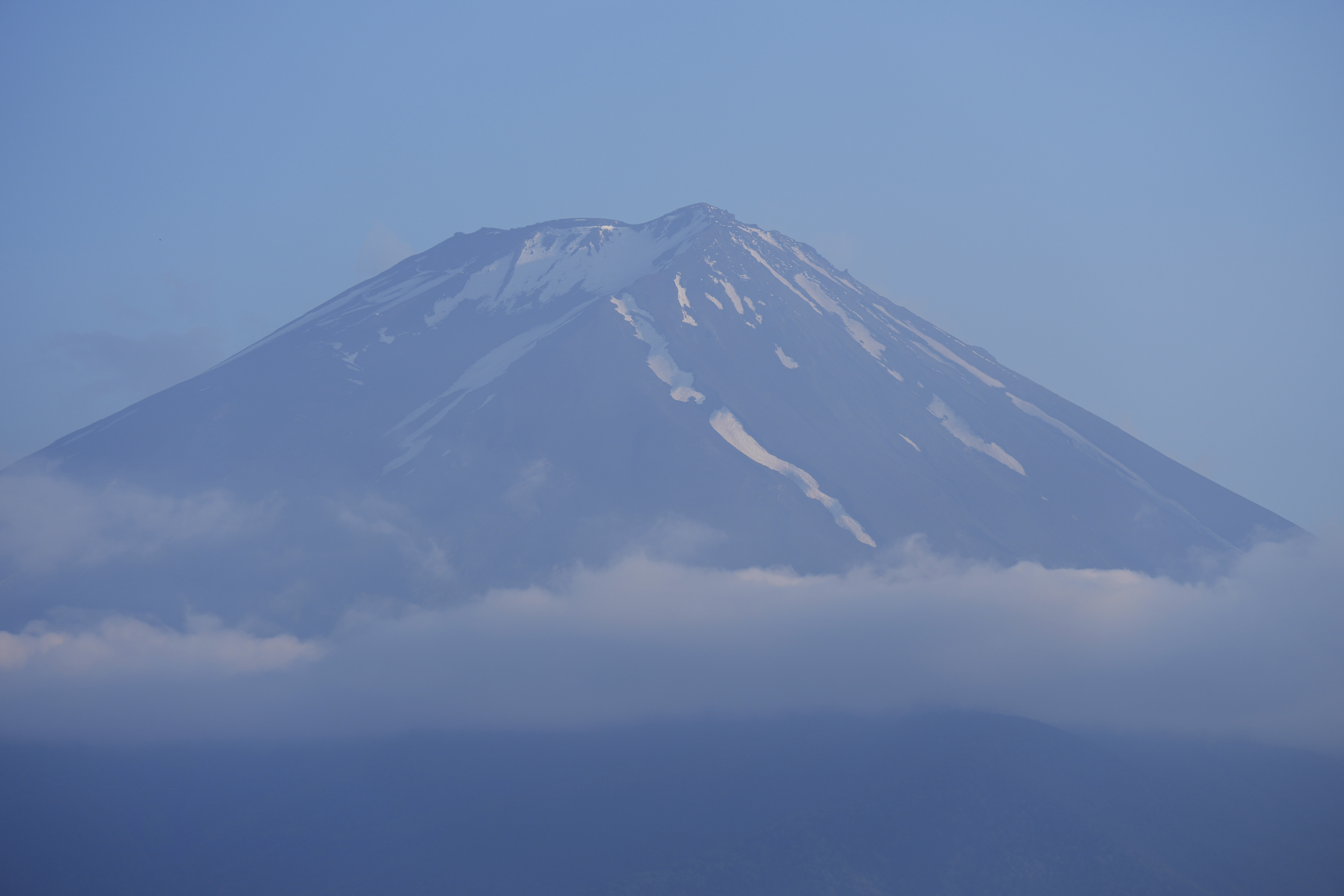 FILE - The top of Mount Fuji is seen in Fujikawaguchiko town, about 110 kilometers (68 miles) west of Tokyo, June 14, 2024. (AP Photo/Hiro Komae, File)