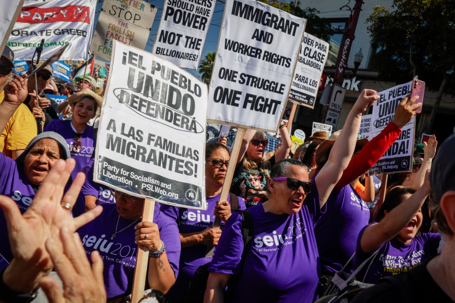 Raven Winchell, of Seui 2015 Long Term Care Givers, raises her first as hundreds gather to protest the Trump Administration while calling for workers over billionaires in the Mission District in San Francisco, Calif., Monday, Sept. 1, 2025. (Bronte Wittpenn/San Francisco Chronicle via AP)