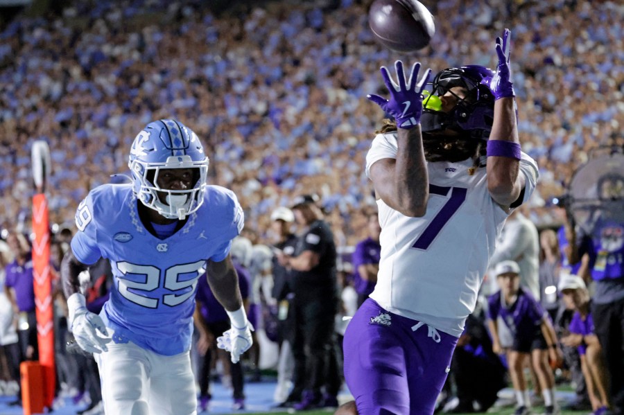 TCU wide receiver Jordan Dwyer (7) hauls in a touchdown pass over North Carolina defensive back Marcus Allen (29) during the first half of an NCAA college football game Monday, Sept. 1, 2025, in Chapel Hill, N.C. (AP Photo/Chris Seward)