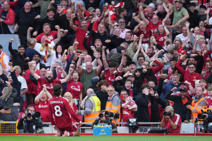 Liverpool's Dominik Szoboszlai celebrates after scoring his sides first goal during the English Premier League soccer match between FC Liverpool and FC Arsenal in Liverpool, England, Sunday, Aug. 31, 2025. (AP Photo/Jon Super)