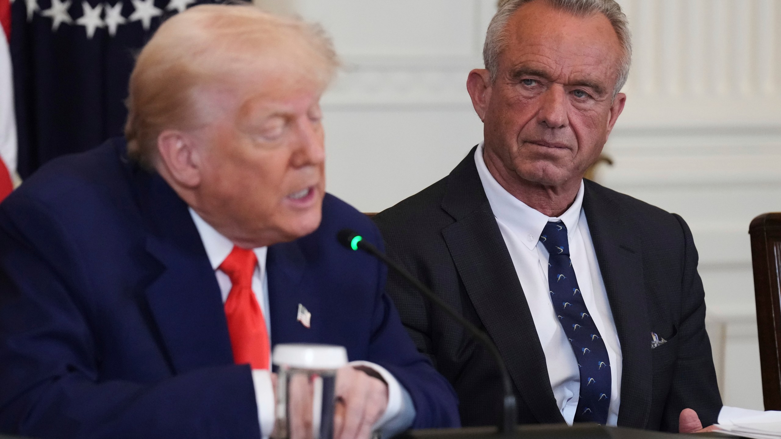 FILE - President Donald Trump, left, speaks as Health and Human Services Secretary Robert F. Kennedy Jr. listens during a Make America Healthy Again (MAHA) Commission Event in the East Room of the White House, Thursday, May 22, 2025, in Washington. (AP Photo/Jacquelyn Martin, File)