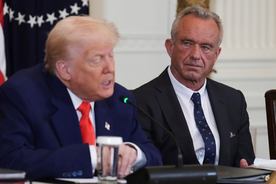FILE - President Donald Trump, left, speaks as Health and Human Services Secretary Robert F. Kennedy Jr. listens during a Make America Healthy Again (MAHA) Commission Event in the East Room of the White House, Thursday, May 22, 2025, in Washington. (AP Photo/Jacquelyn Martin, File)