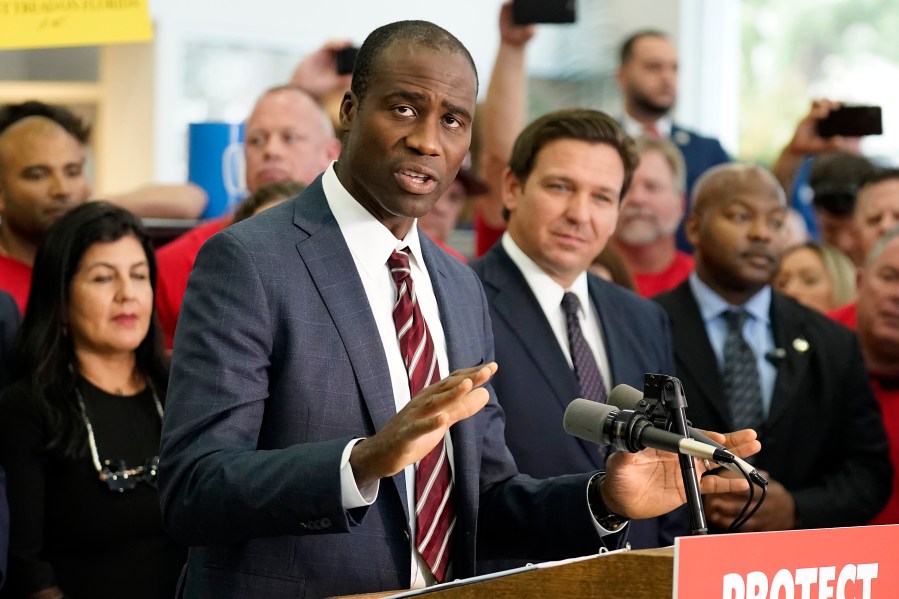 FILE - Florida Surgeon General Dr. Joseph Ladapo gestures as speaks to supporters and members of the media before a bill signing by Gov. Ron DeSantis, Nov. 18, 2021, in Brandon, Fla. (AP Photo/Chris O'Meara, File)
